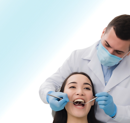 Dentist treating a woman in a dental chair using professional dental tools